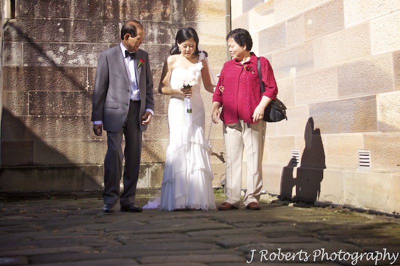 Bride preparing to walk down aisle with mother and father - wedding photography sydney
